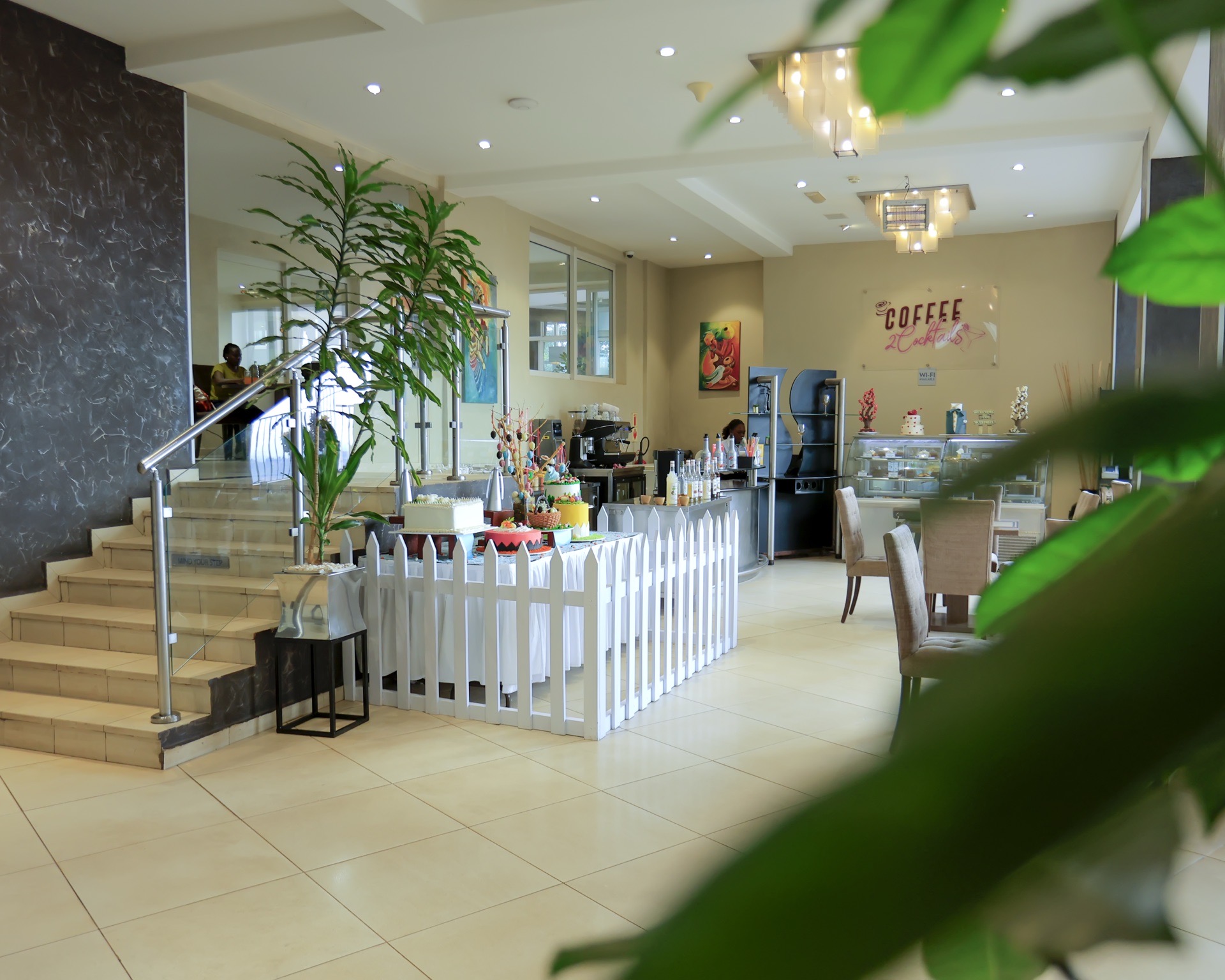 Coffee 2 Cocktails cake display case, staircase and coffee bar at Skyz Hotel Kampala