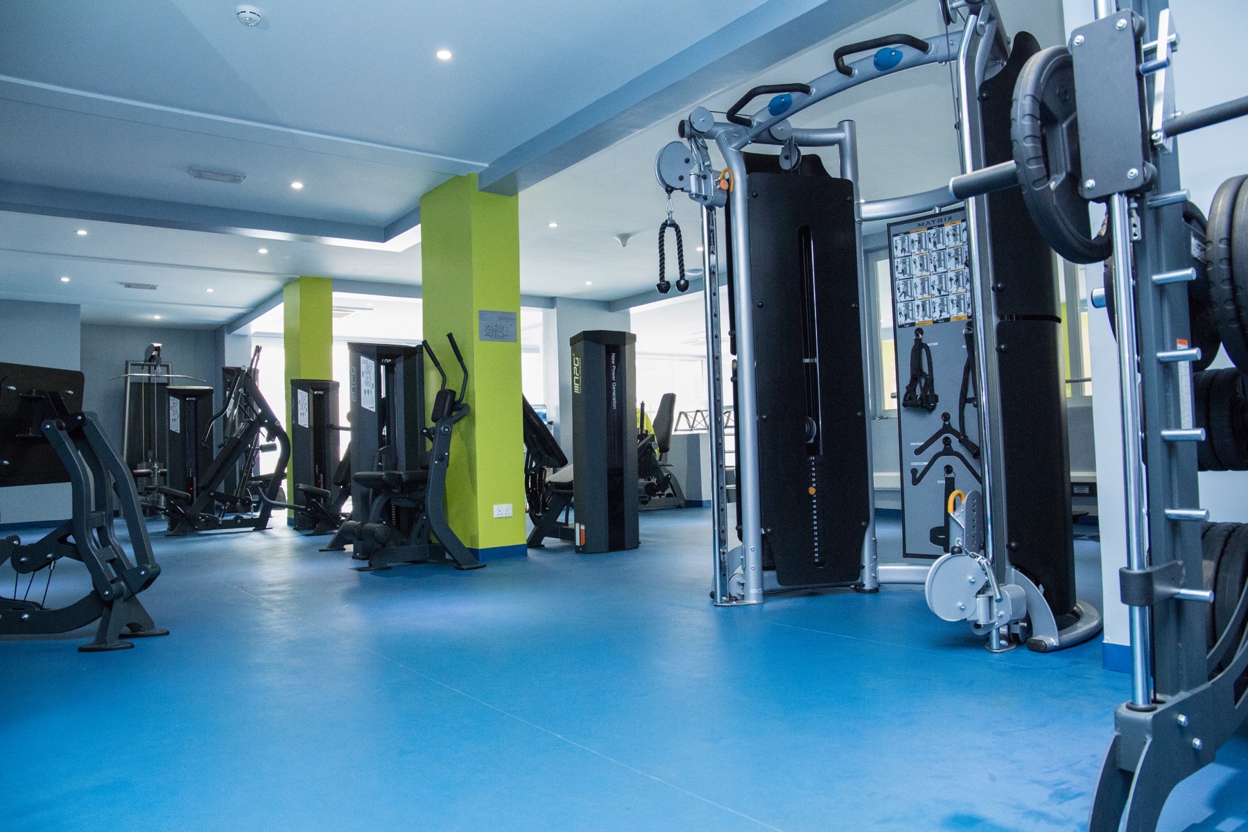 Treadmills lined up by the windows in the Skyz Gym