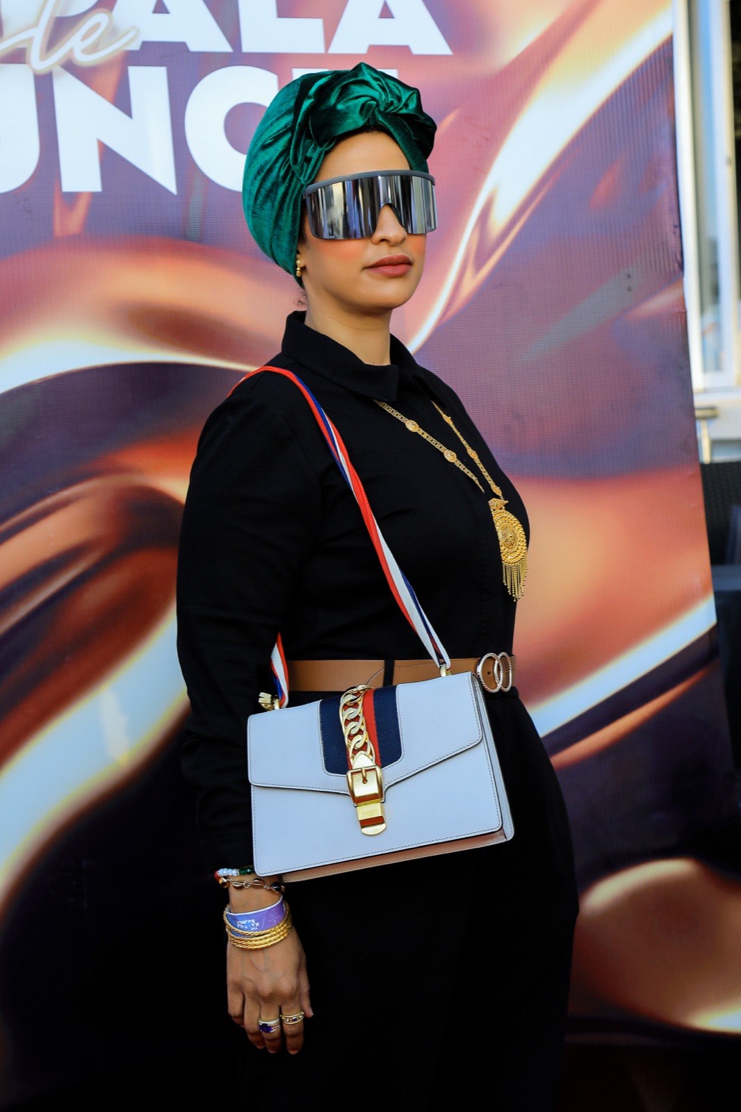 A guest in a green turban poses at The Kampala Style Brunch, June 2024