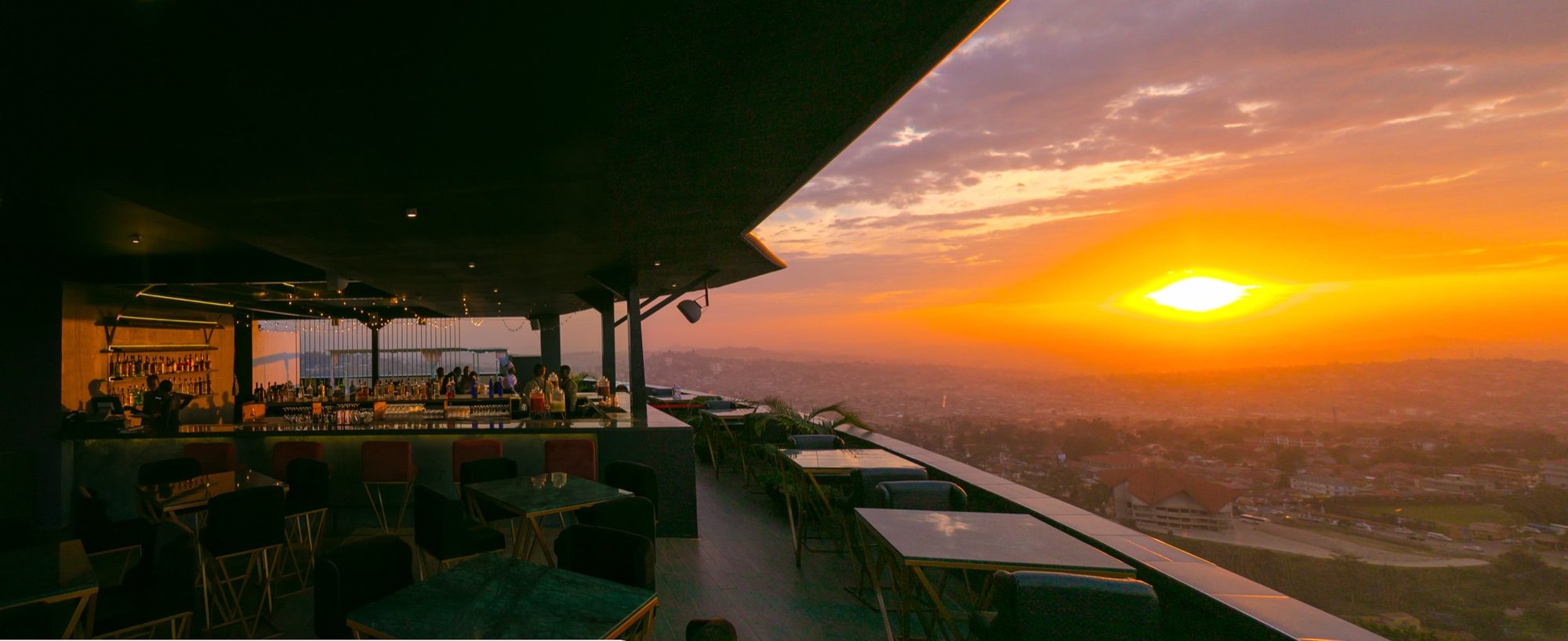 Skyz Deck rooftop venue with pergola and panoramic city views at dusk