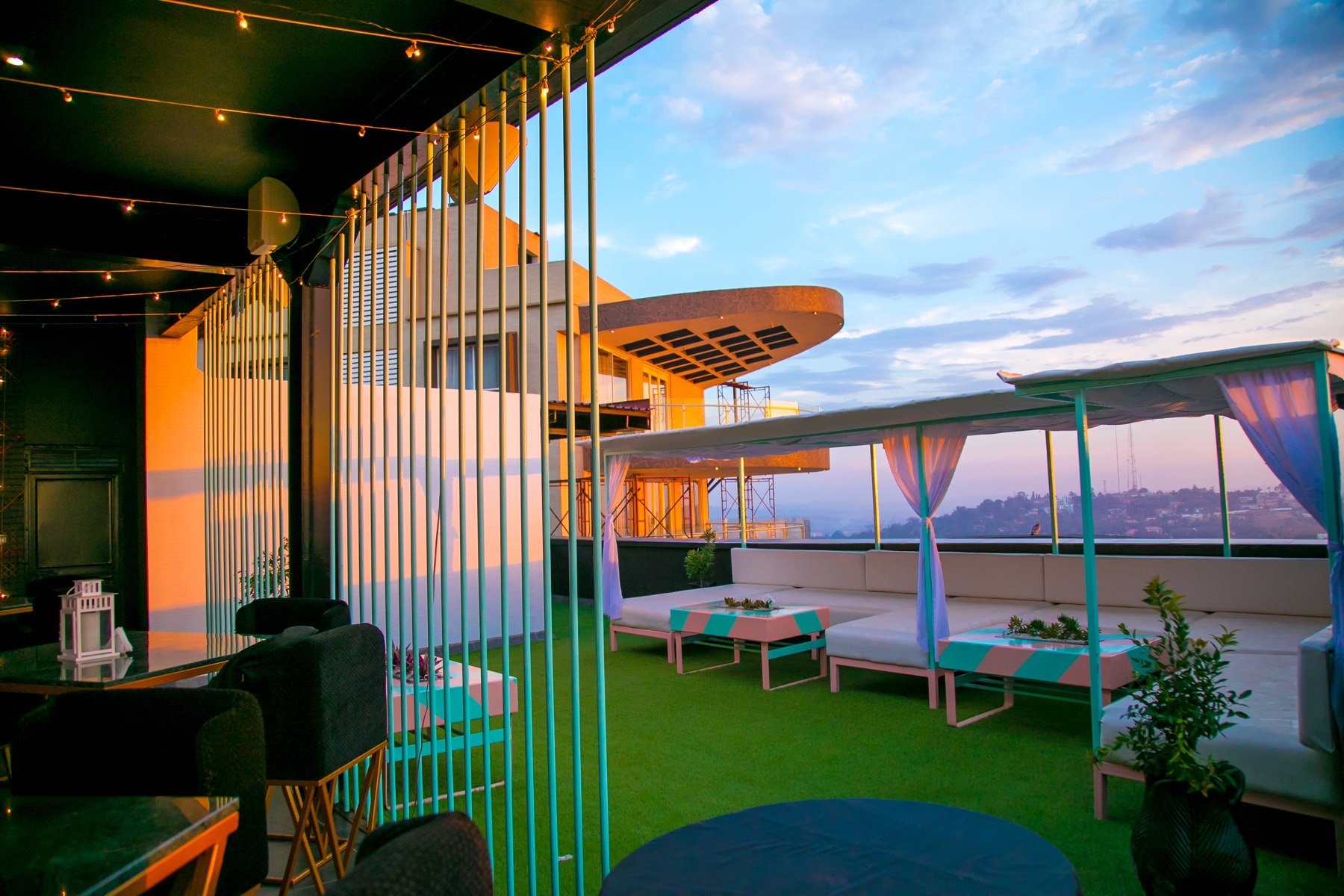 Rooftop tables dressed in blue and white linens for a daytime celebration