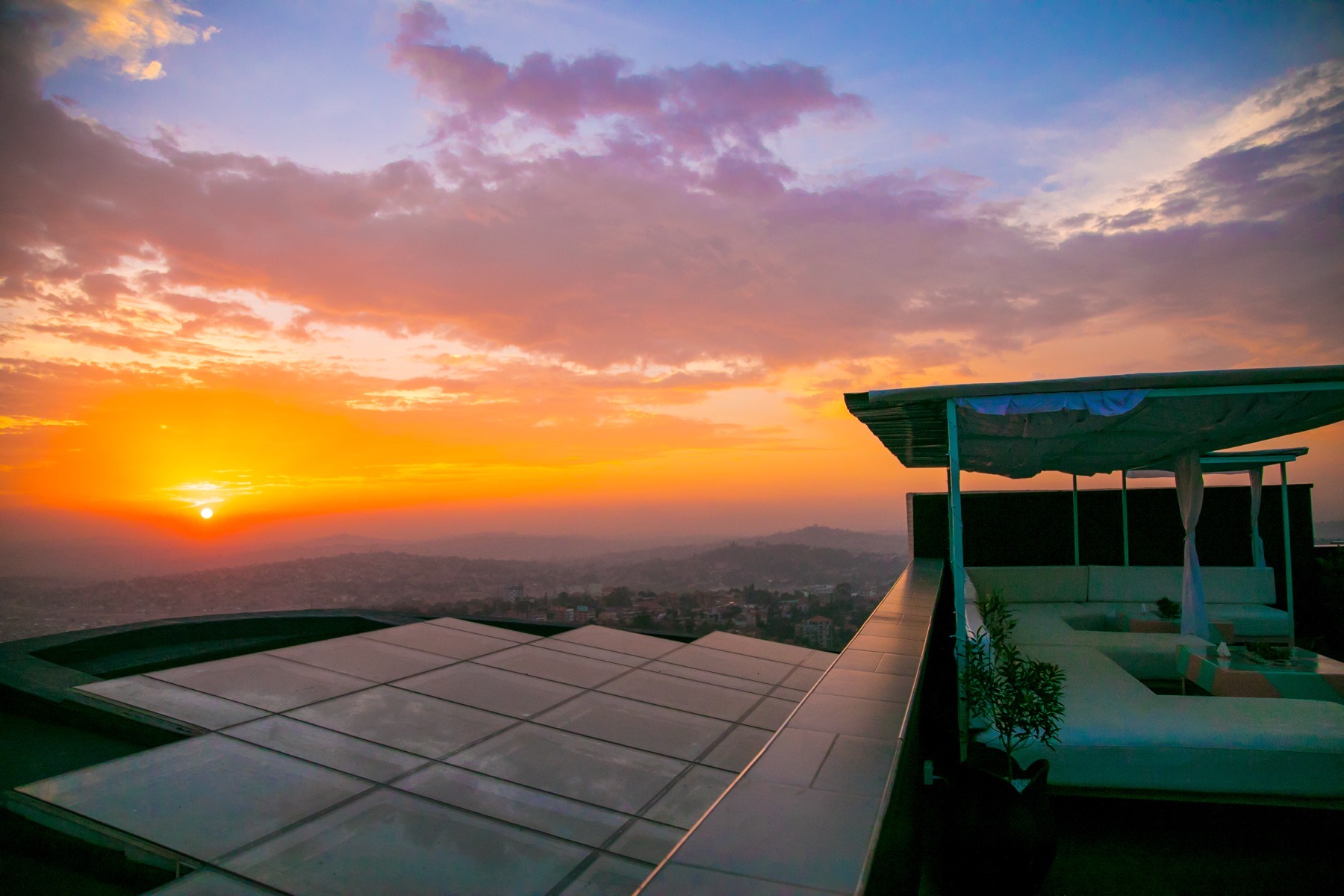 Ninety9 Rooftop bar silhouetted against a burning orange sunset