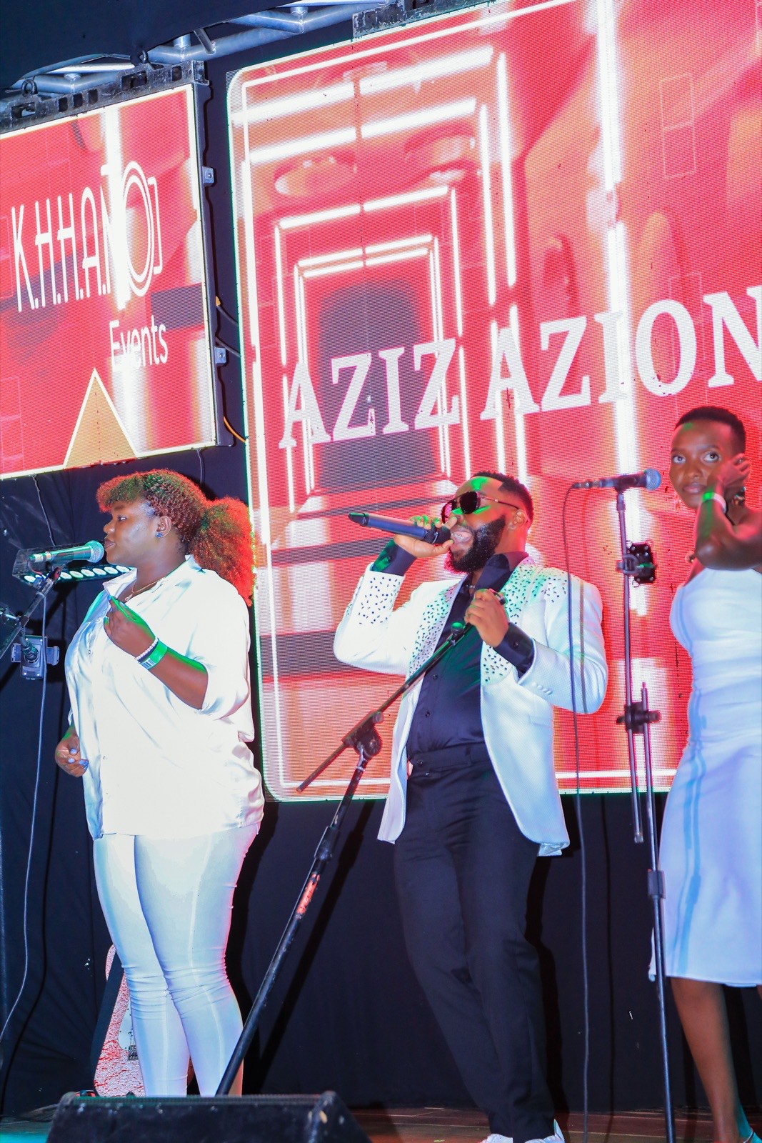 Aziz Azion singing on stage at Tropicanna Poolside