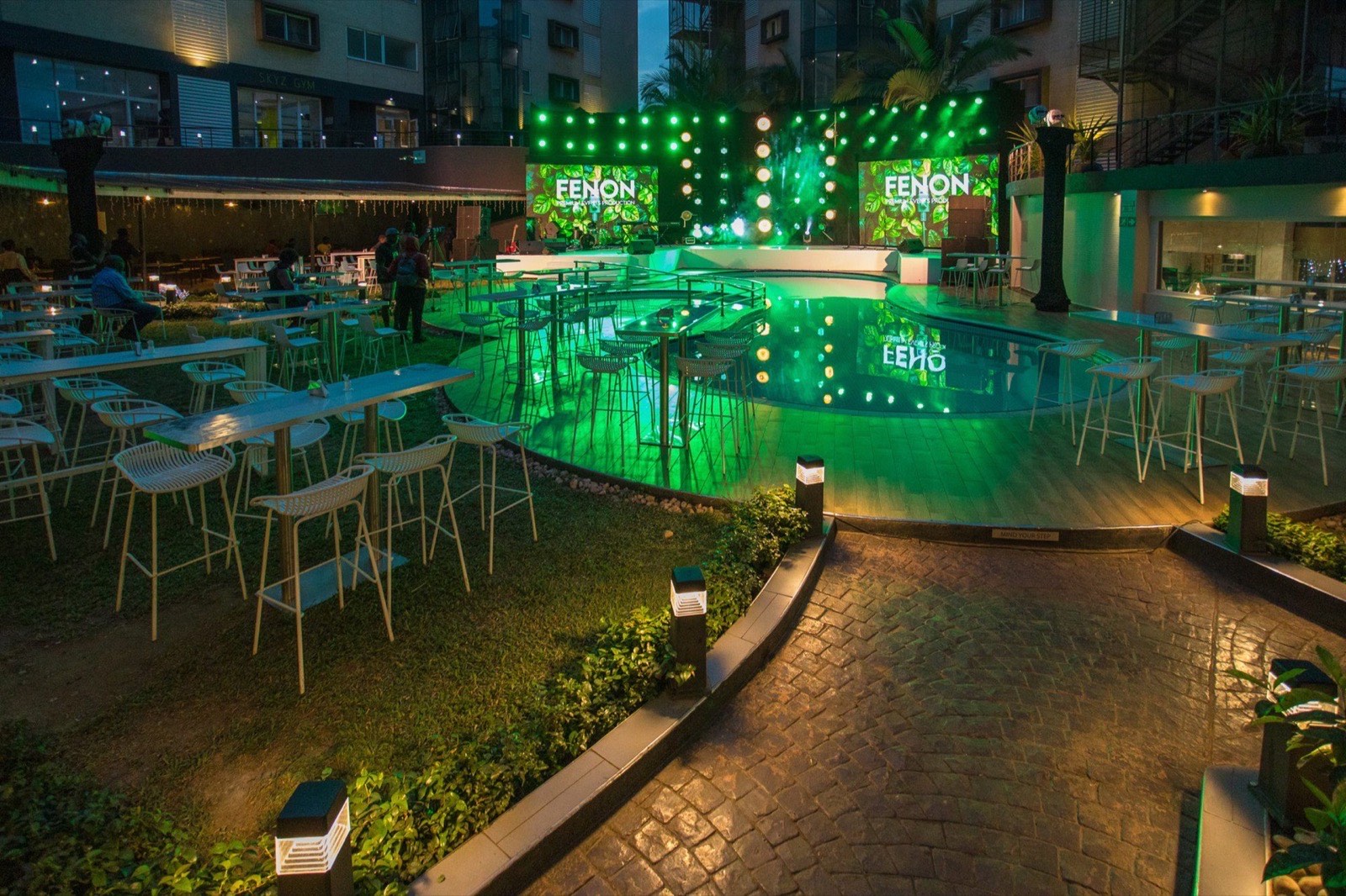 The Pool Terrace Bar and pool deck lit green for an evening event
